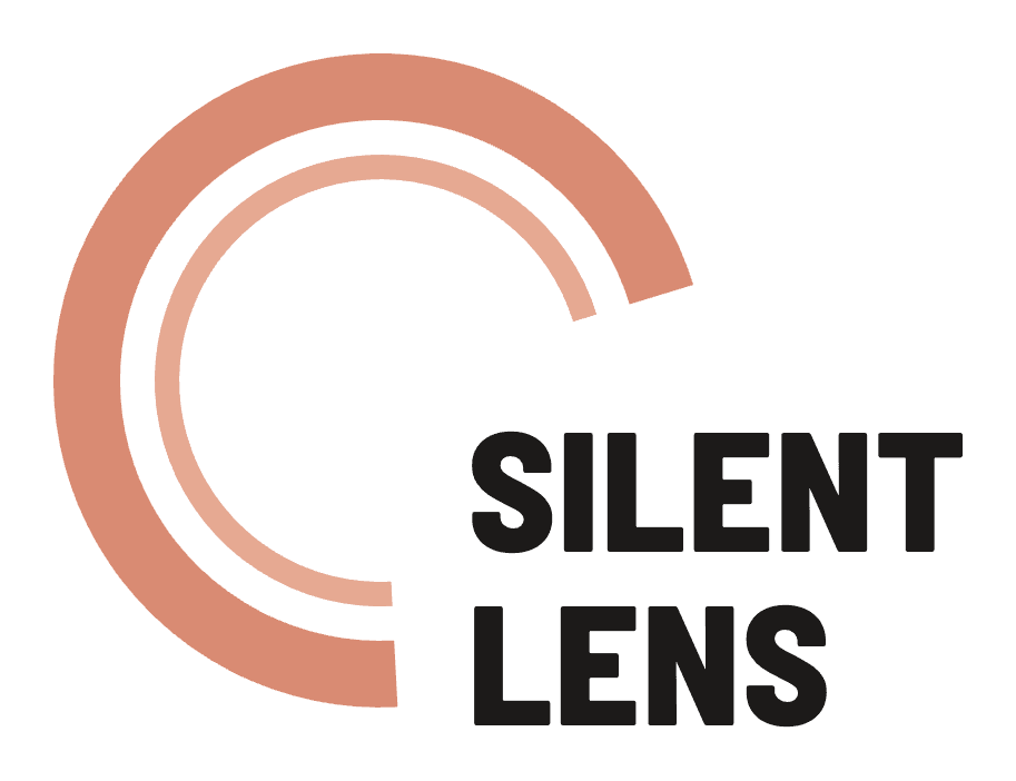 The Silent Lens logo: two large concentric terracotta rings forming a camera lens, with the wordmark SILENT over LENS in heavy dark-ink condensed type set at the lower right.